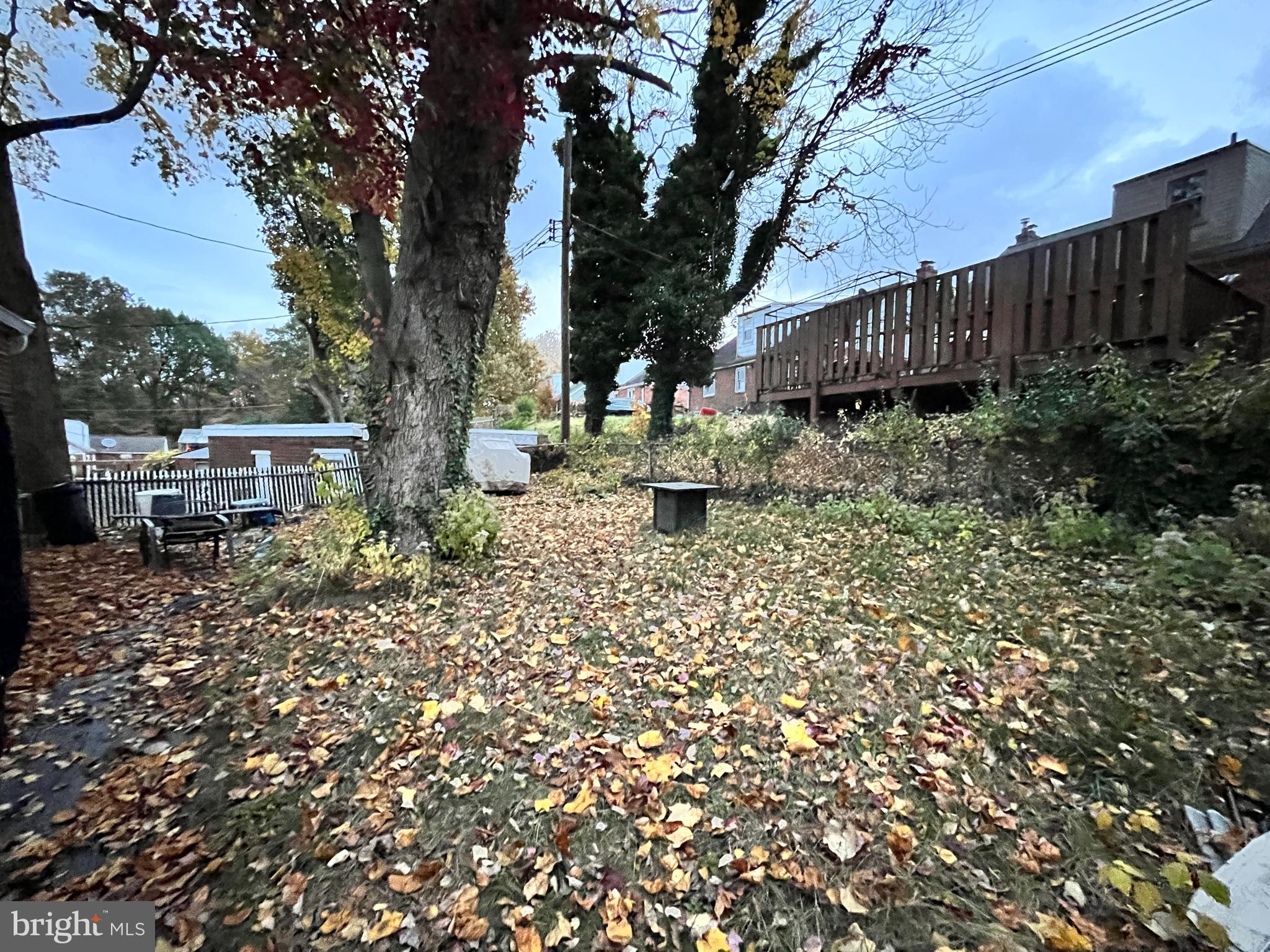 1304 Manor Road Lansdowne, PA 19050 - Photo 27 of 27 a view of a backyard with wooden fence and a large tree