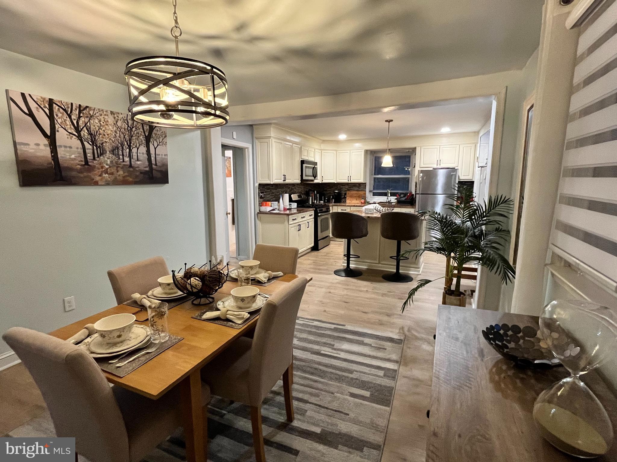 1304 Manor Road Lansdowne, PA 19050 - Photo 5 of 27 a view of a dining room and livingroom with furniture wooden floor a chandelier