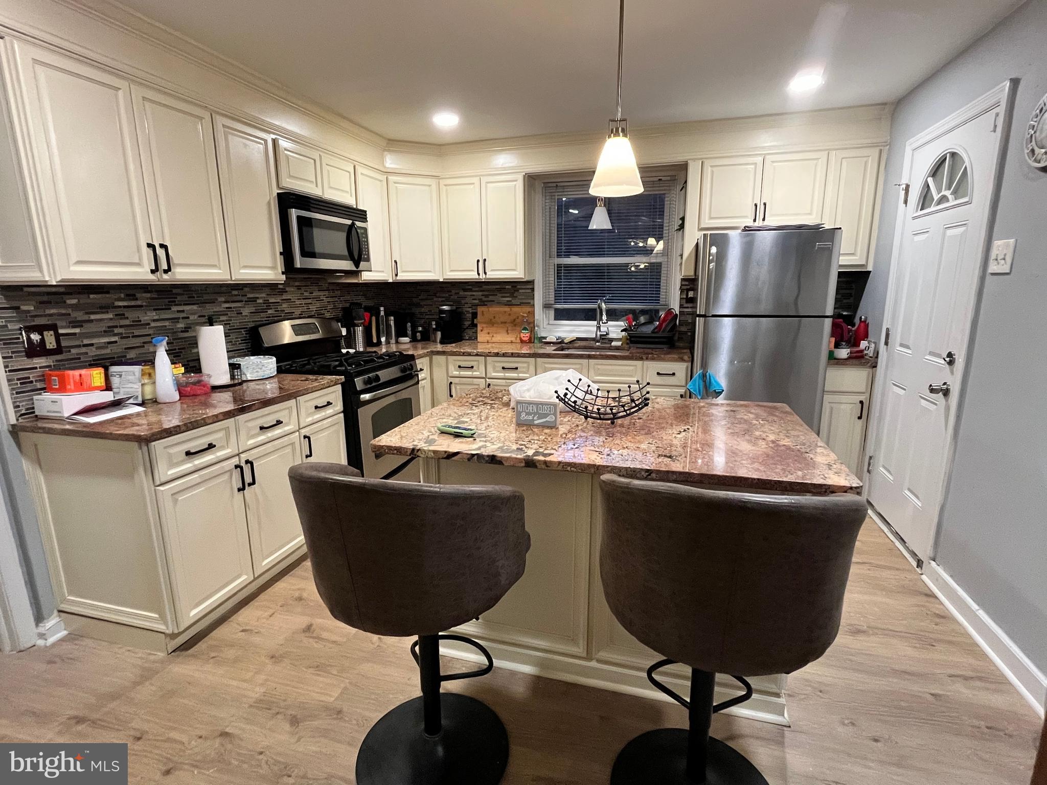 1304 Manor Road Lansdowne, PA 19050 - Photo 7 of 27 a kitchen with stainless steel appliances granite countertop a sink refrigerator and microwave
