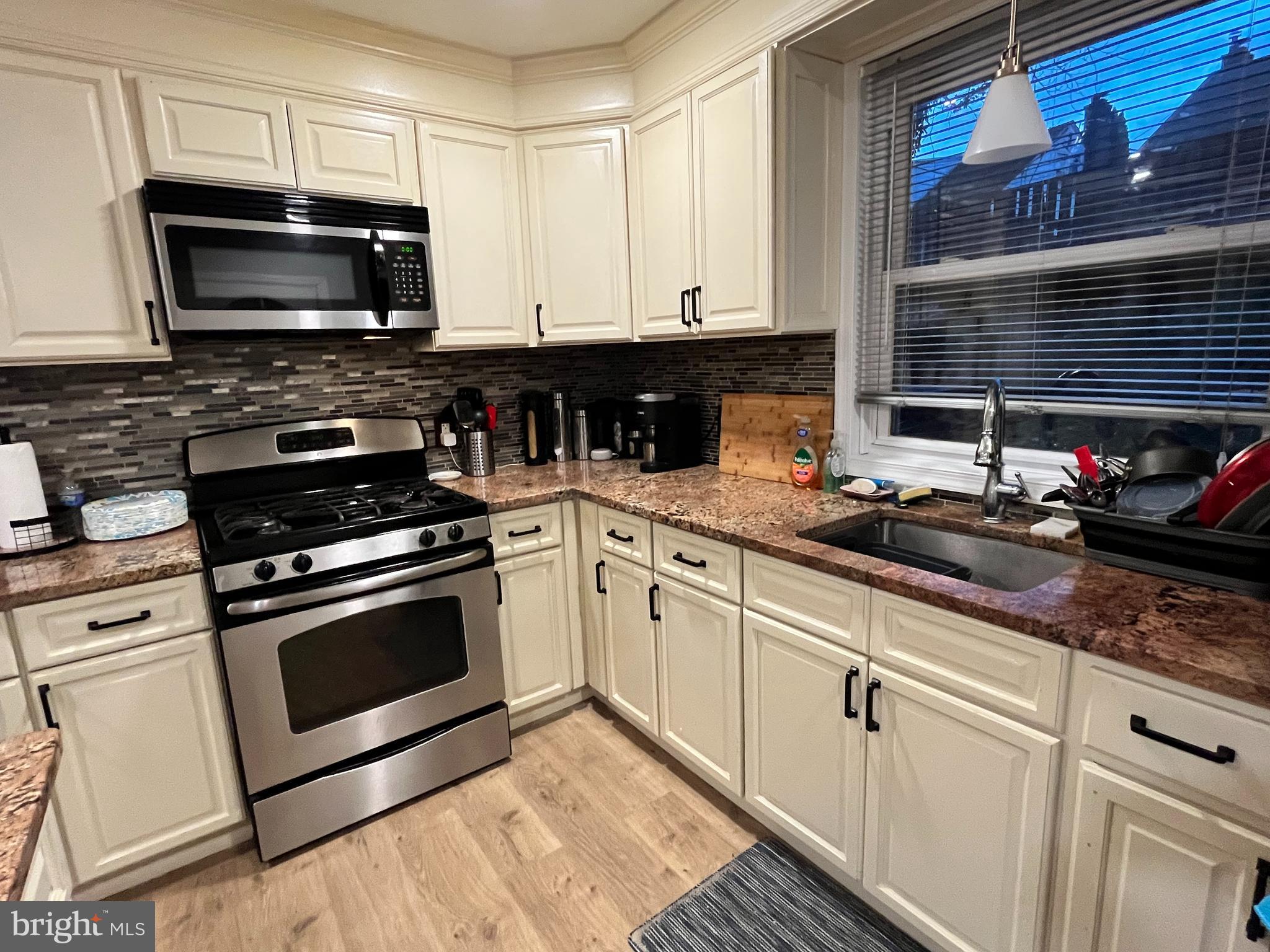 1304 Manor Road Lansdowne, PA 19050 - Photo 9 of 27 a kitchen with stainless steel appliances a stove a sink and a microwave