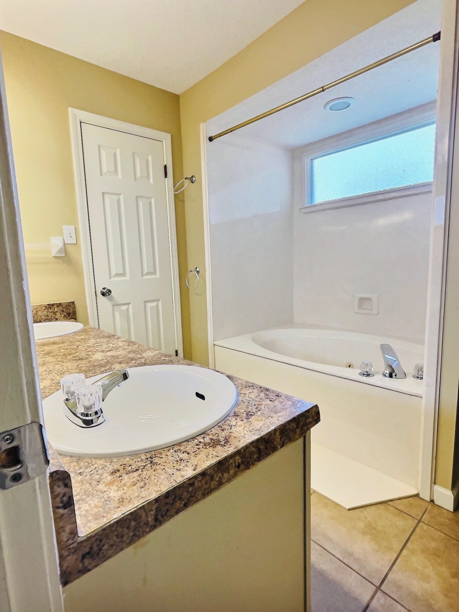 6946 Snyder Road Memphis, TN 38141 - Photo 7 of 12 a bathroom with a granite countertop sink and a mirror