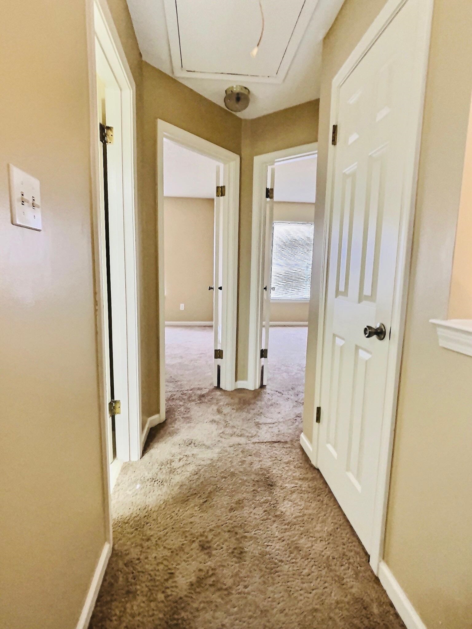 6946 Snyder Road Memphis, TN 38141 - Photo 9 of 12 a view of a hallway with wooden floor and a bathroom