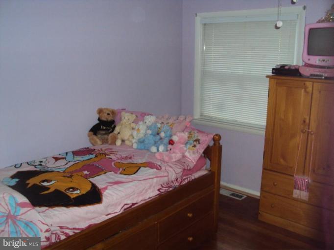 9006 Tammy Road Nottingham, MD 21236 - Photo 5 of 14 a bed room with a bed and a mirror