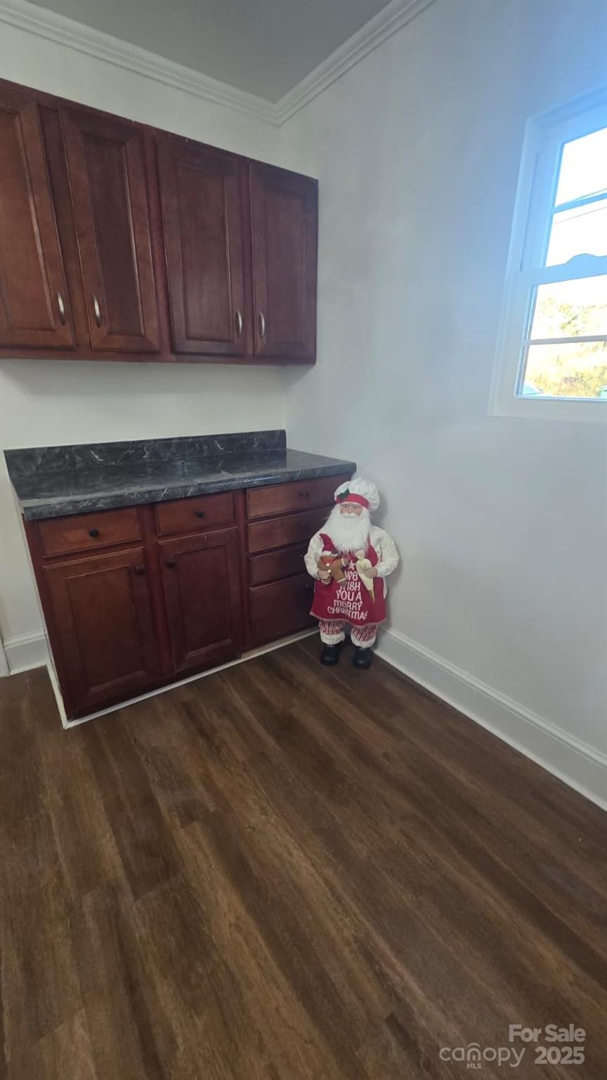 416 Oakland Road Spindale, NC 28160 - Photo 11 of 26 an empty room with wooden floor and cabinet
