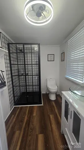 a view of a livingroom with furniture and hardwood floor