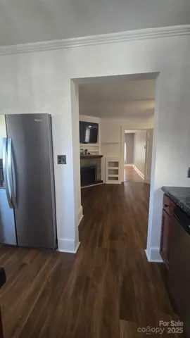 a view of living room and kitchen with wooden floor