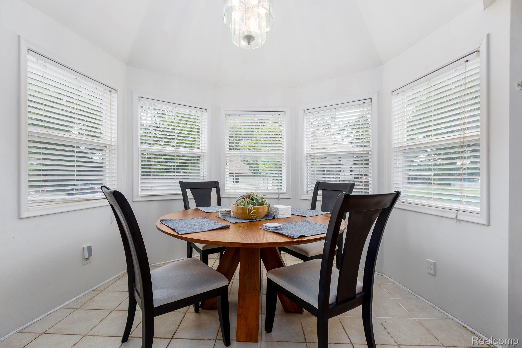 401 Pointe Tremble Road Algonac, MI 48001 - Photo 17 of 40 Curved dining alcove featuring five windows with white blinds, a recessed ceiling, and tiled flooring