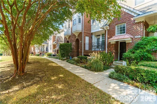 front view of a house with a tree