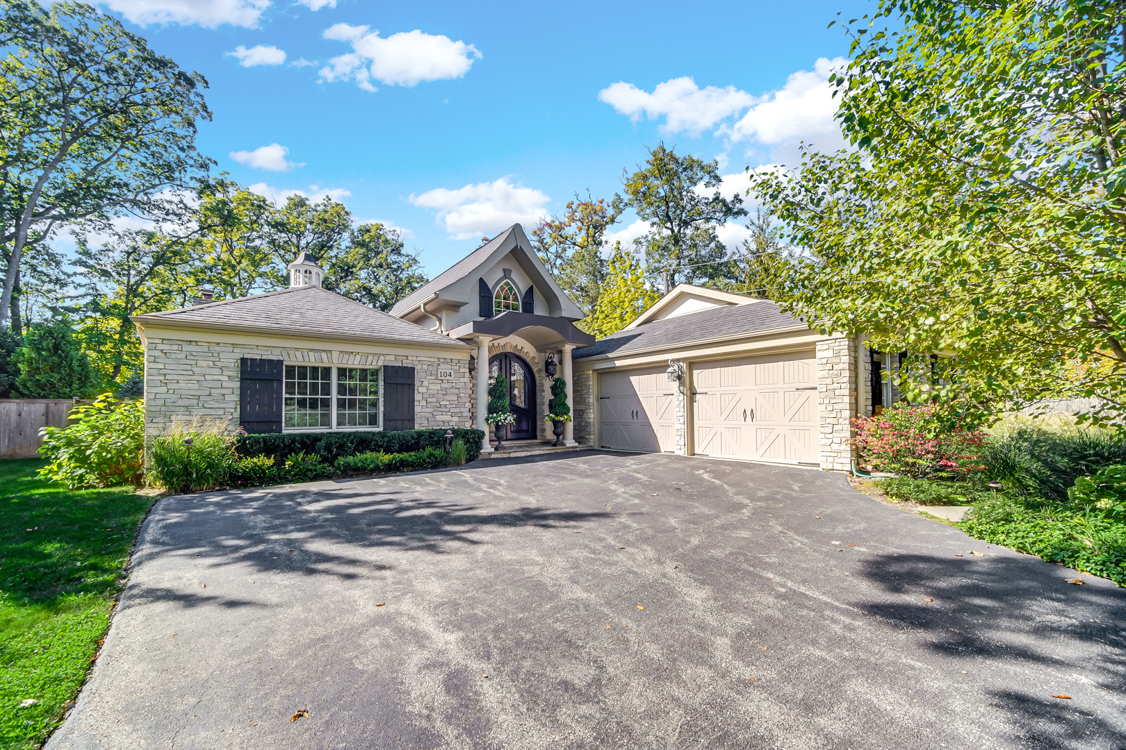104 Moffett Road Lake Bluff, IL 60044 - Photo 4 of 40 a front view of a house with a yard and a garage