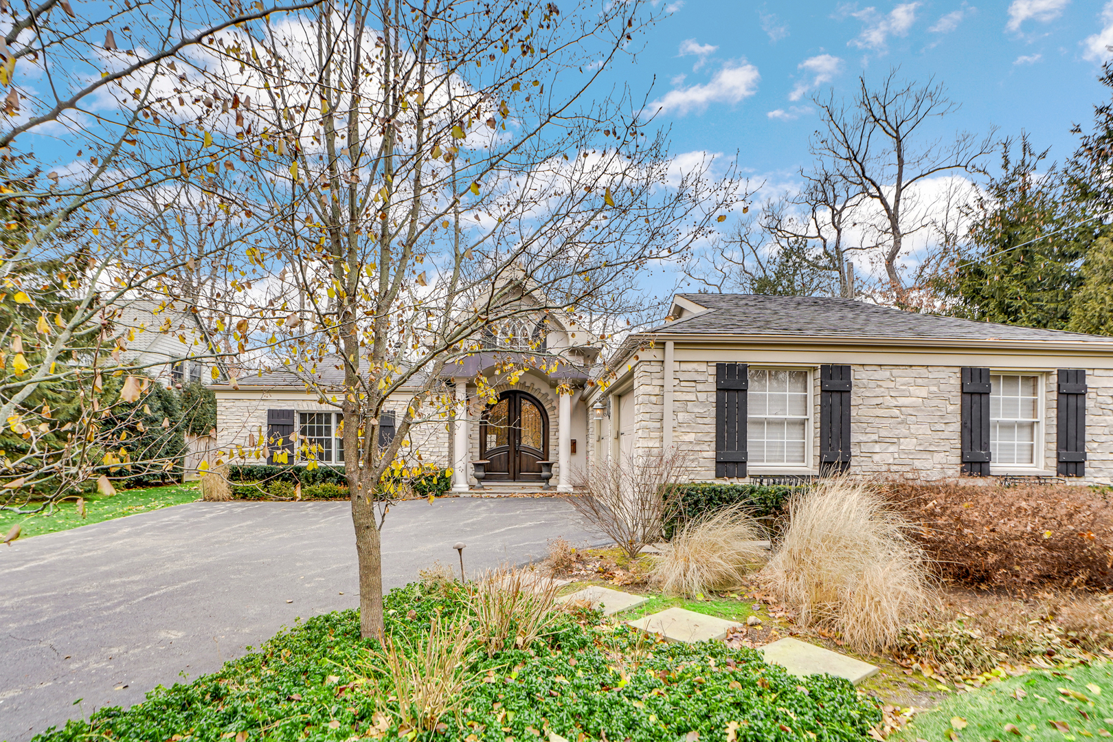 104 Moffett Road Lake Bluff, IL 60044 - Photo 5 of 40 a front view of a house with a yard garage and outdoor seating