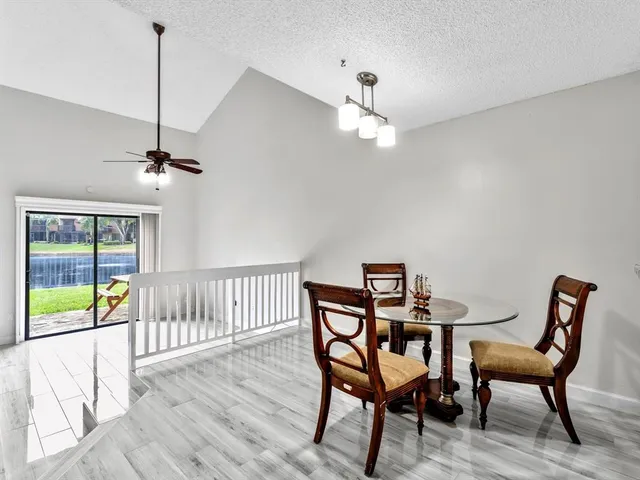 a view of a dining room with furniture wooden floor and chandelier