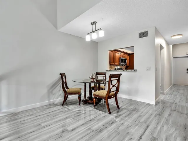 a dining room with furniture and wooden floor