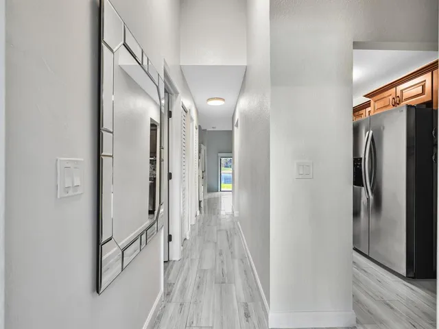 a view of a hallway with wooden floor