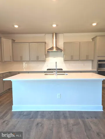 a view of kitchen with kitchen island sink and center island