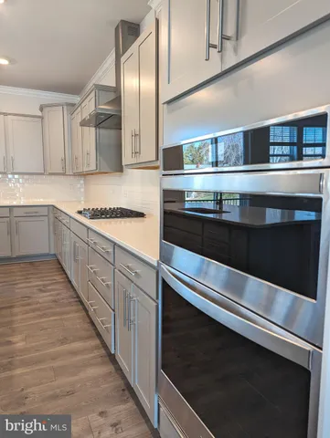 a kitchen with stainless steel appliances and white cabinets