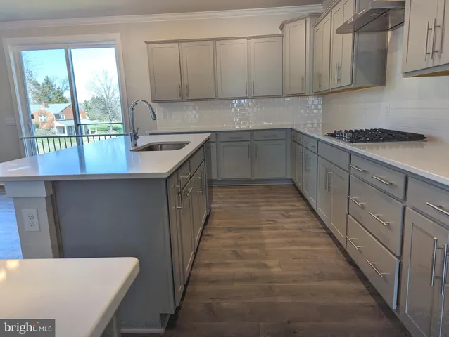 a kitchen with a sink and cabinets