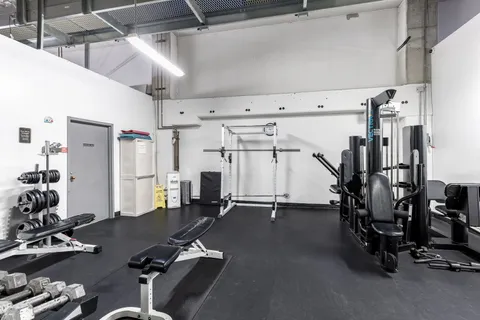 a room with gym equipment and a large window