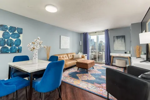 a living room with furniture and a chandelier