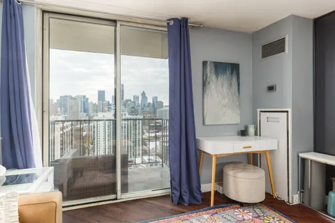 a en suite bathroom with a granite countertop sink and a mirror