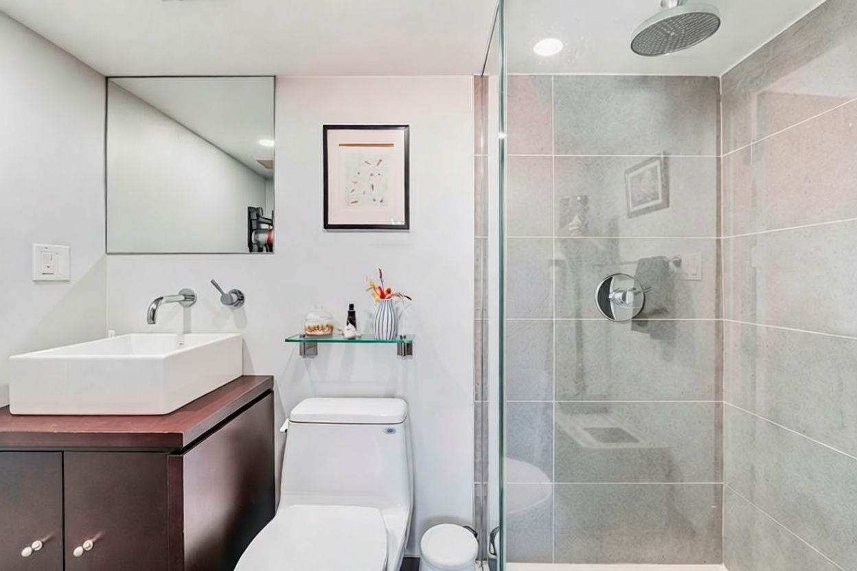 96 Woodpoint Road, Unit 3A Brooklyn, NY 11211 - Photo 10 of 12 a bathroom with a sink toilet vanity and shower