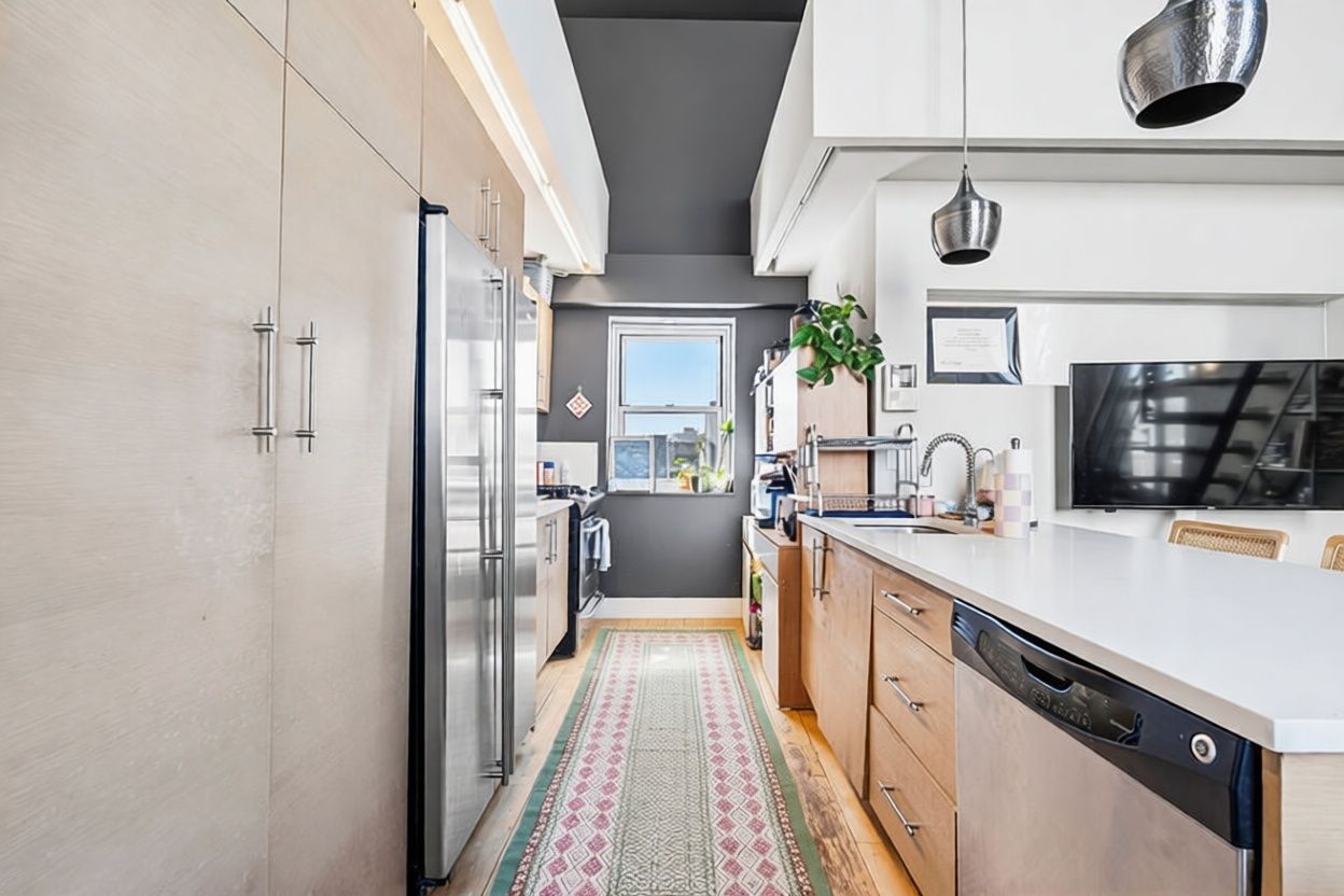 96 Woodpoint Road, Unit 3A Brooklyn, NY 11211 - Photo 3 of 12 a kitchen with stainless steel appliances a refrigerator and cabinets