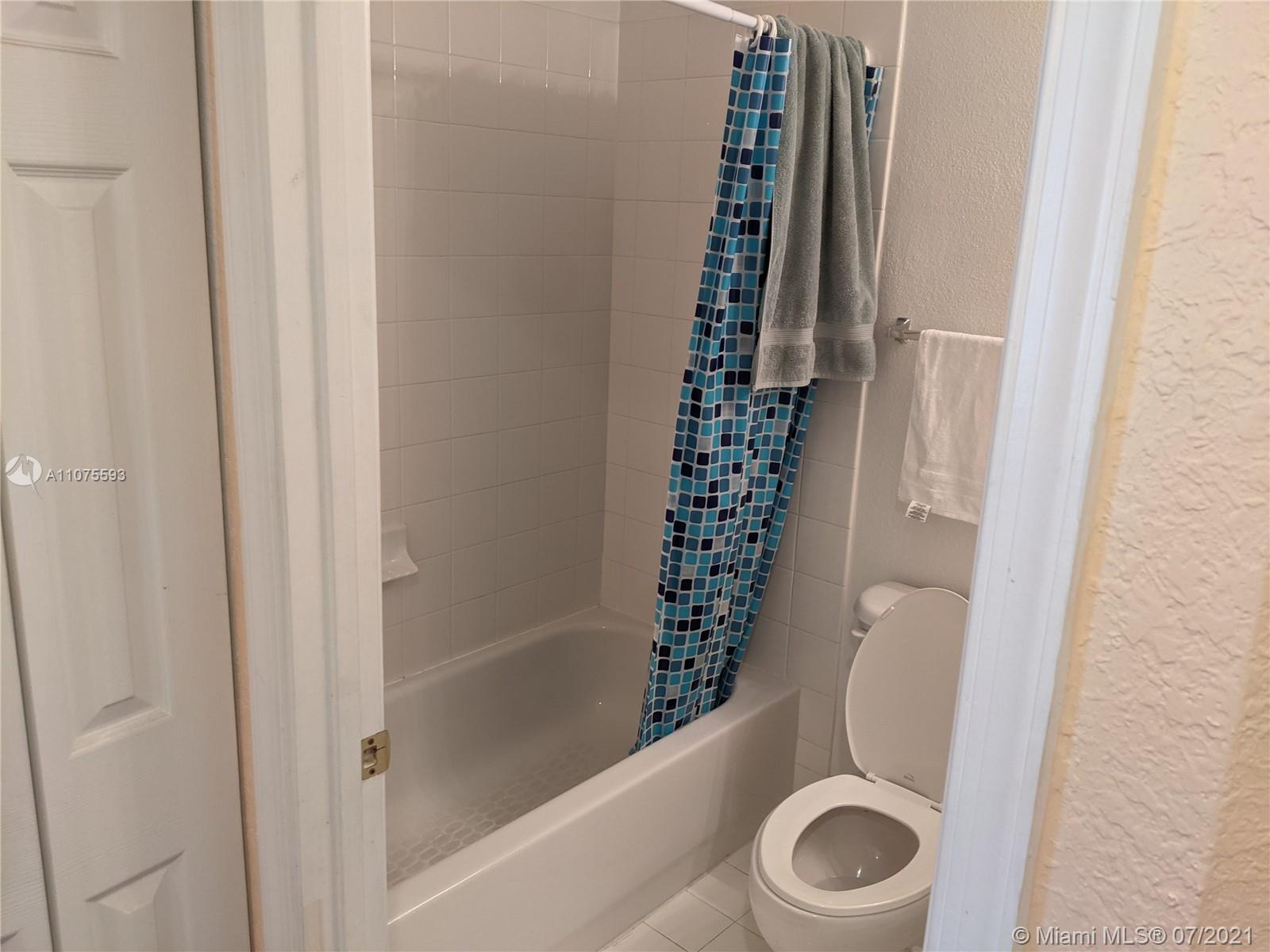 2731 Southwest 83rd Terrace, Unit 101 Miramar, FL 33025 - Photo 3 of 28 a bathroom with a toilet and a shower