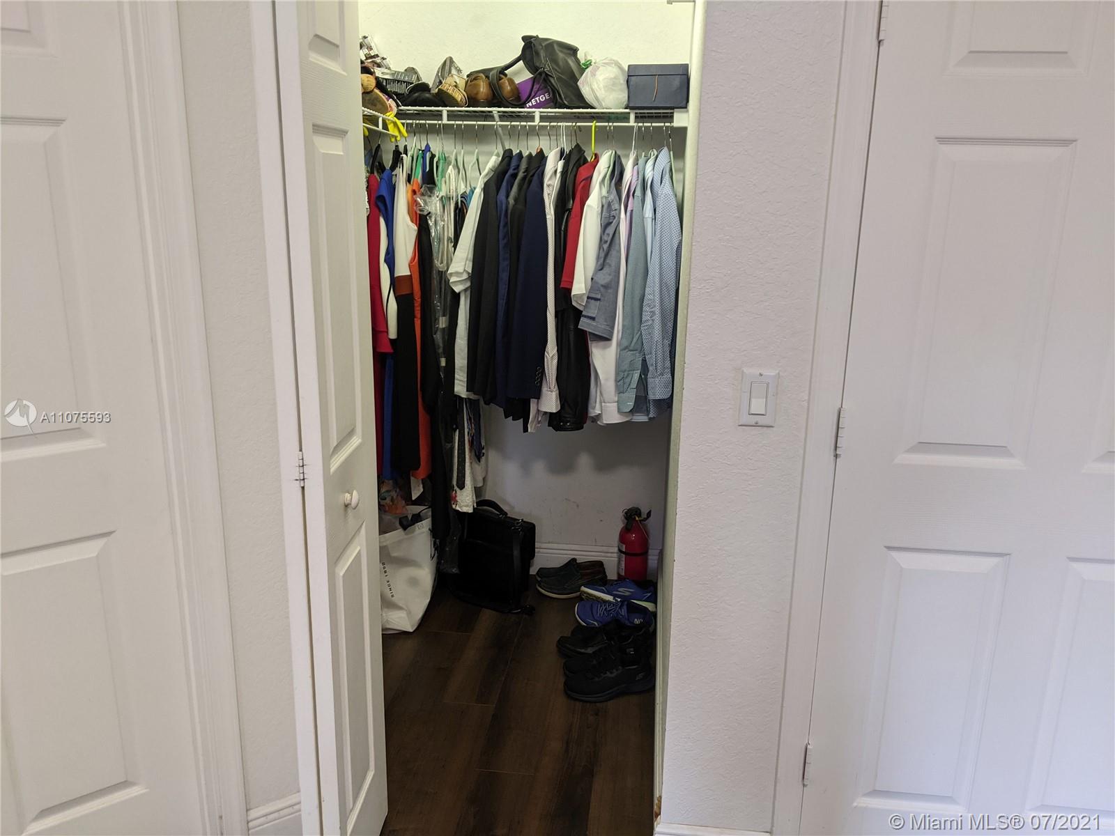 2731 Southwest 83rd Terrace, Unit 101 Miramar, FL 33025 - Photo 22 of 28 a view of walk in closet with clothes