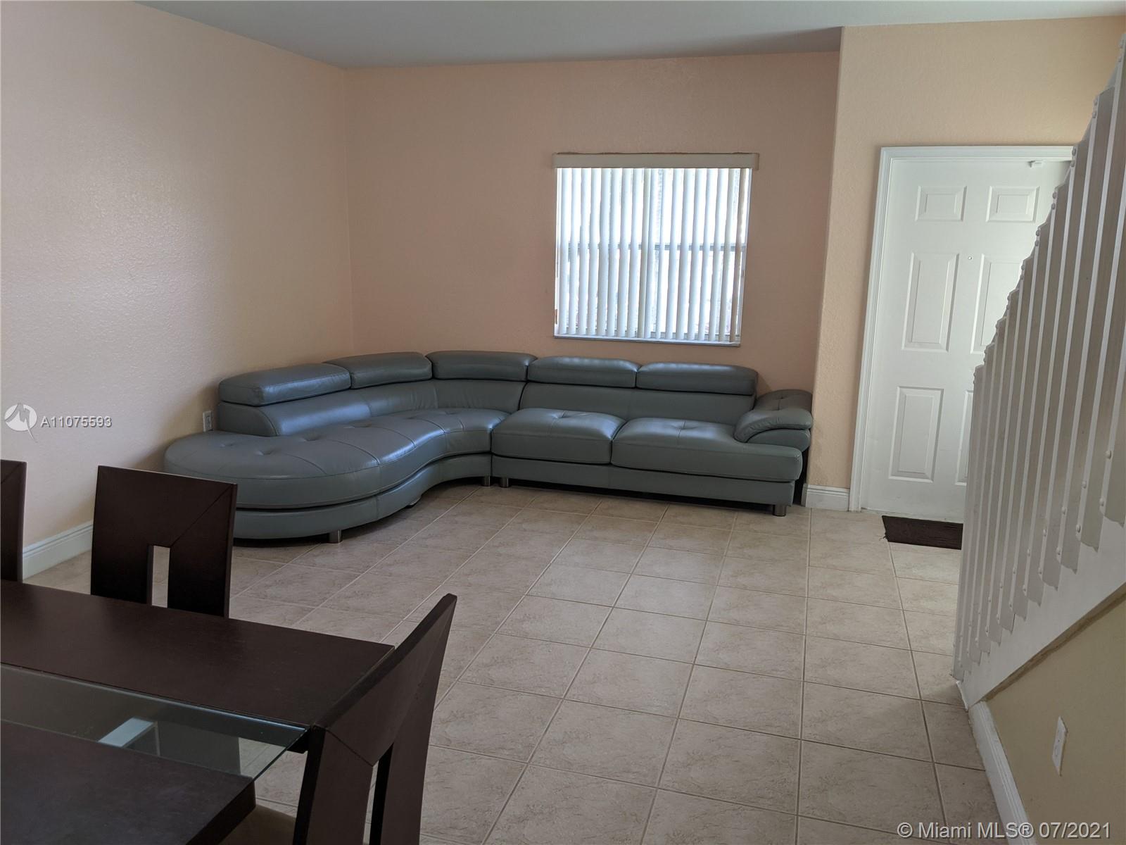 2731 Southwest 83rd Terrace, Unit 101 Miramar, FL 33025 - Photo 8 of 28 a living room with furniture and a window