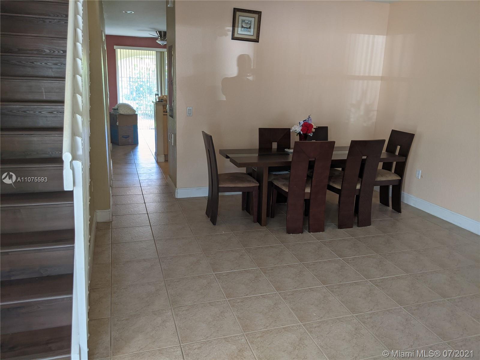 2731 Southwest 83rd Terrace, Unit 101 Miramar, FL 33025 - Photo 9 of 28 a dining room with furniture and wooden floor