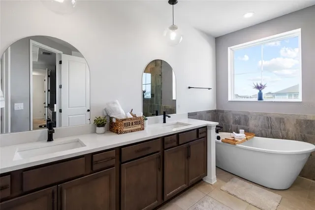 a bedroom with bed and a large window