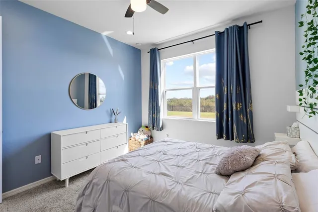 a bedroom with furniture and a flat screen tv
