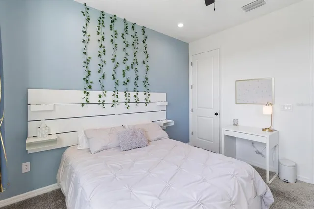 a bedroom with a bed and a couch