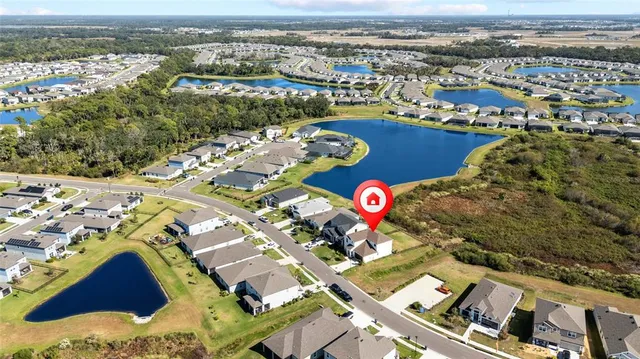 a kitchen with stainless steel appliances granite countertop a stove a refrigerator a oven a sink with a dining table and chairs