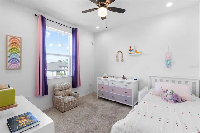 a view of a chairs and table in patio next to a lake
