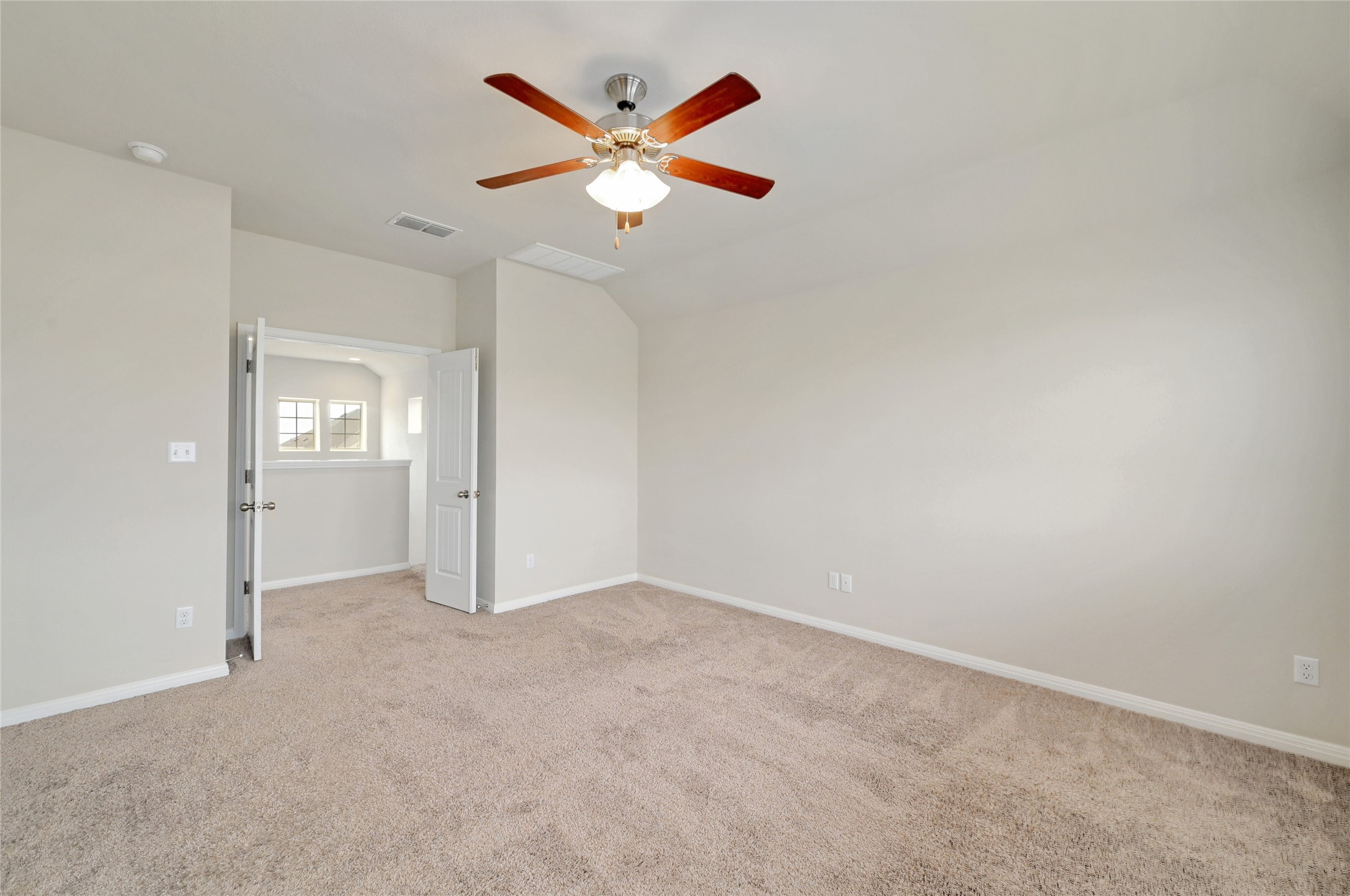 702 Nautical Loop Kyle, TX 78640 - Photo 18 of 27 The property features a spacious room with light-colored carpet and neutral walls