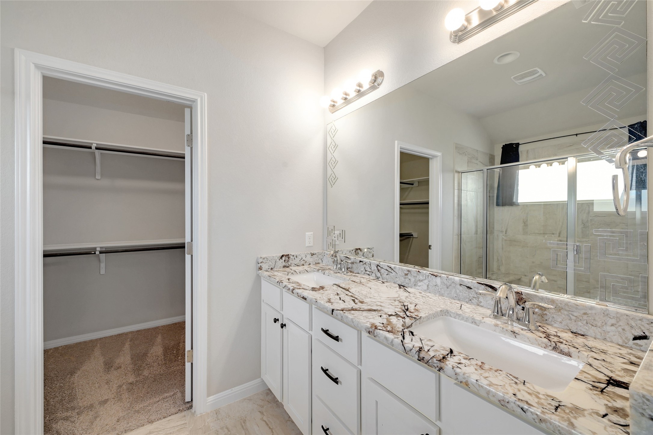 702 Nautical Loop Kyle, TX 78640 - Photo 19 of 27 Bathroom featuring a vanity with two rectangular sinks, granite countertops, and white cabinetry