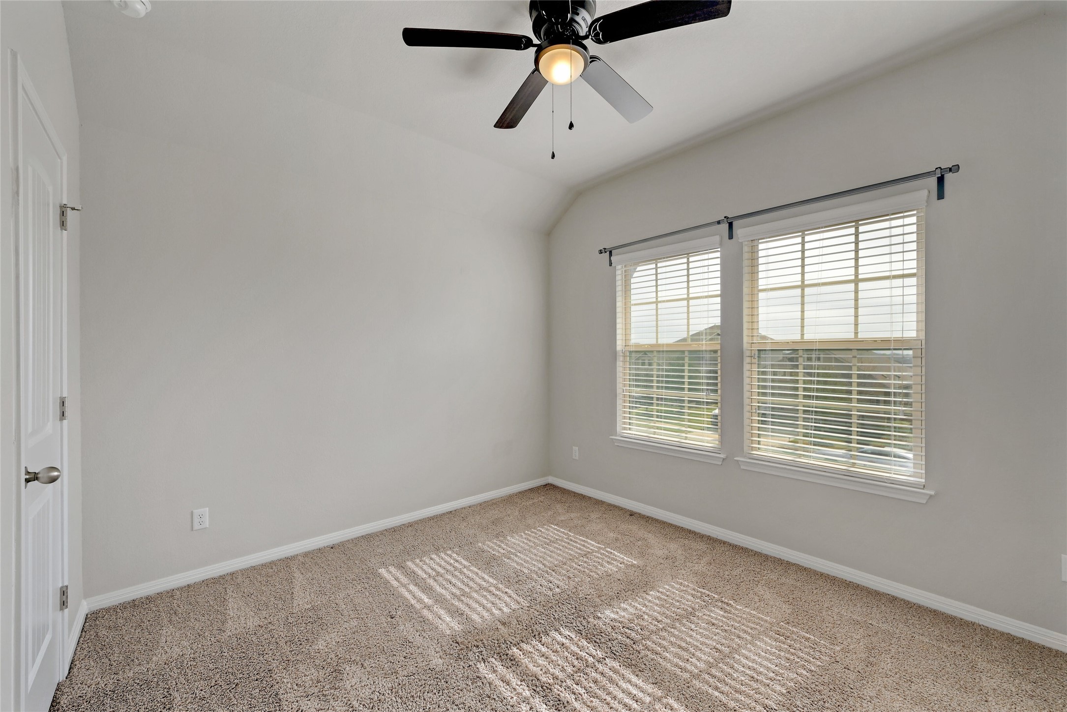 702 Nautical Loop Kyle, TX 78640 - Photo 21 of 27 This room features light-colored walls, carpeted floors, and a ceiling fan with an integrated light fixture