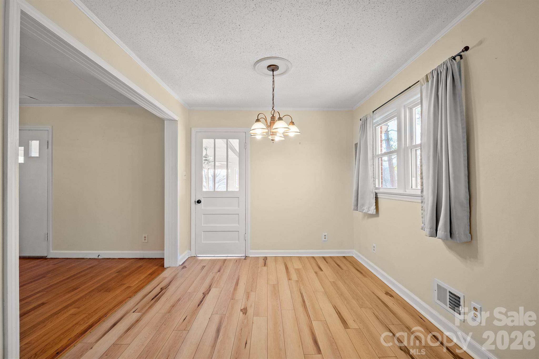 6264 Highway 221 Marion, NC 28752 - Photo 18 of 41 a view of a room with wooden floor chandelier and windows