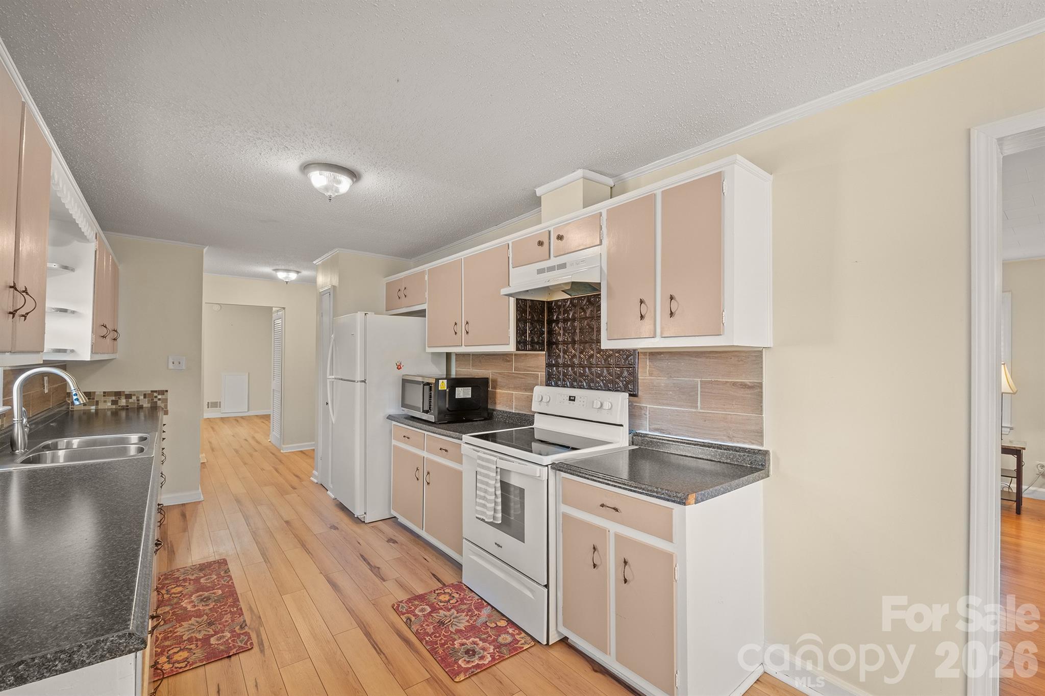 6264 Highway 221 Marion, NC 28752 - Photo 19 of 41 a kitchen with stainless steel appliances kitchen island granite countertop a sink a stove top oven a counter space and cabinets