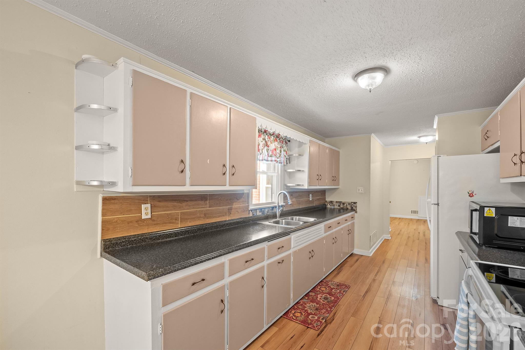 6264 Highway 221 Marion, NC 28752 - Photo 20 of 41 a kitchen with granite countertop a sink stove and cabinets