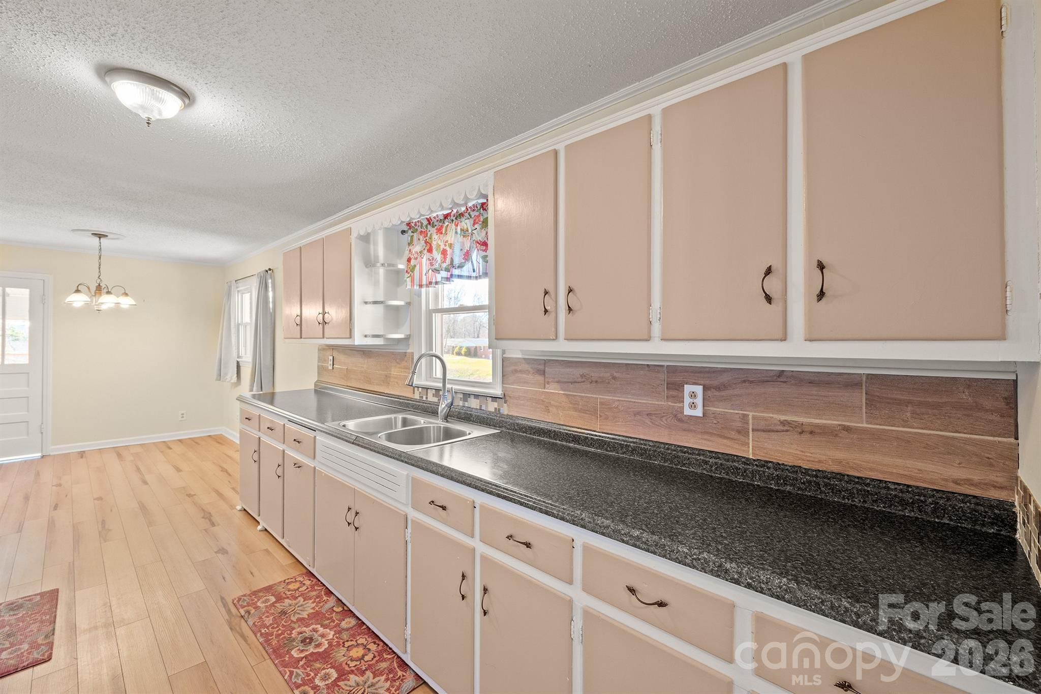 6264 Highway 221 Marion, NC 28752 - Photo 21 of 41 a kitchen with granite countertop white cabinets and a sink