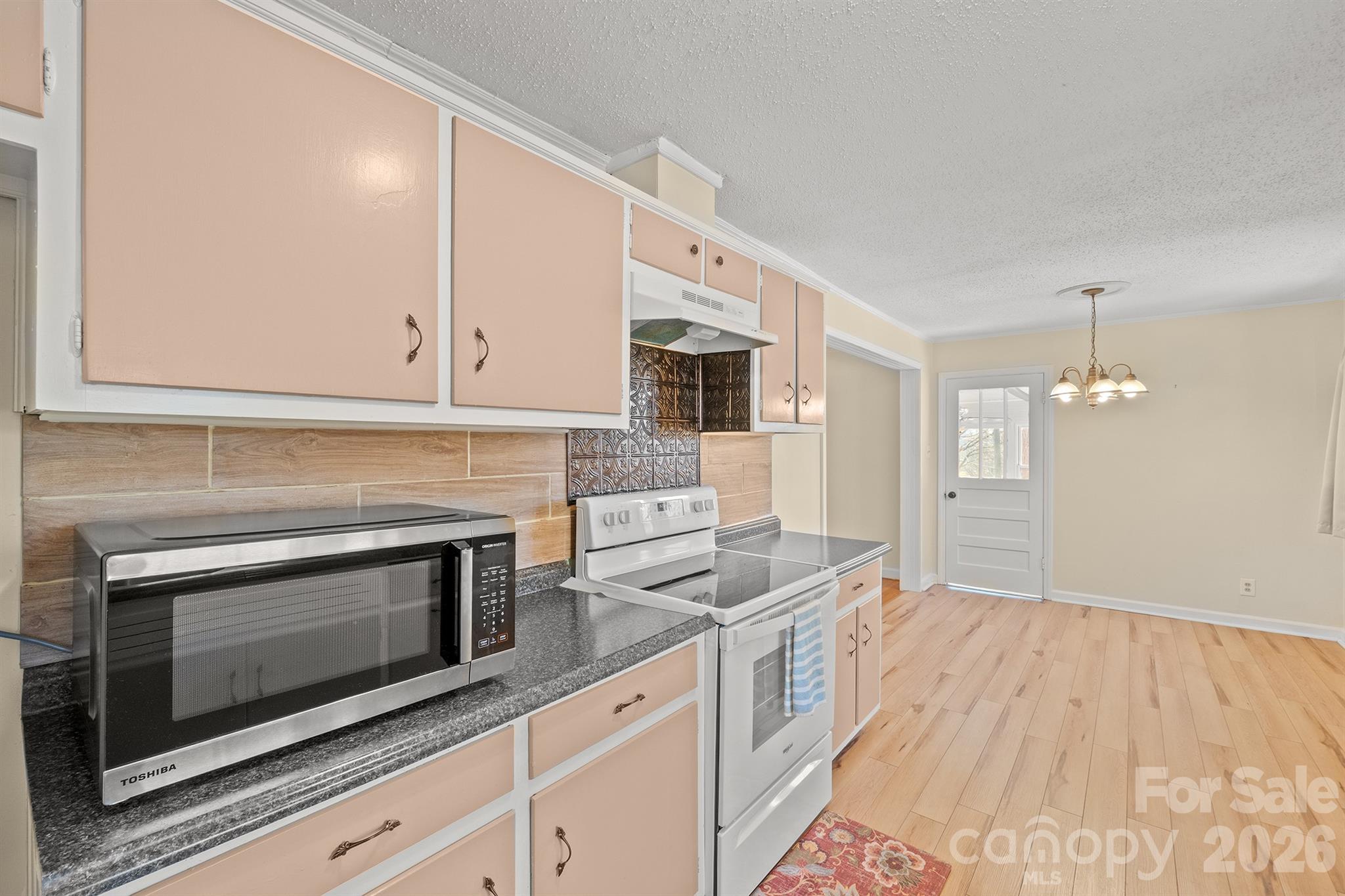 6264 Highway 221 Marion, NC 28752 - Photo 22 of 41 a kitchen with granite countertop cabinets stainless steel appliances and wooden floor