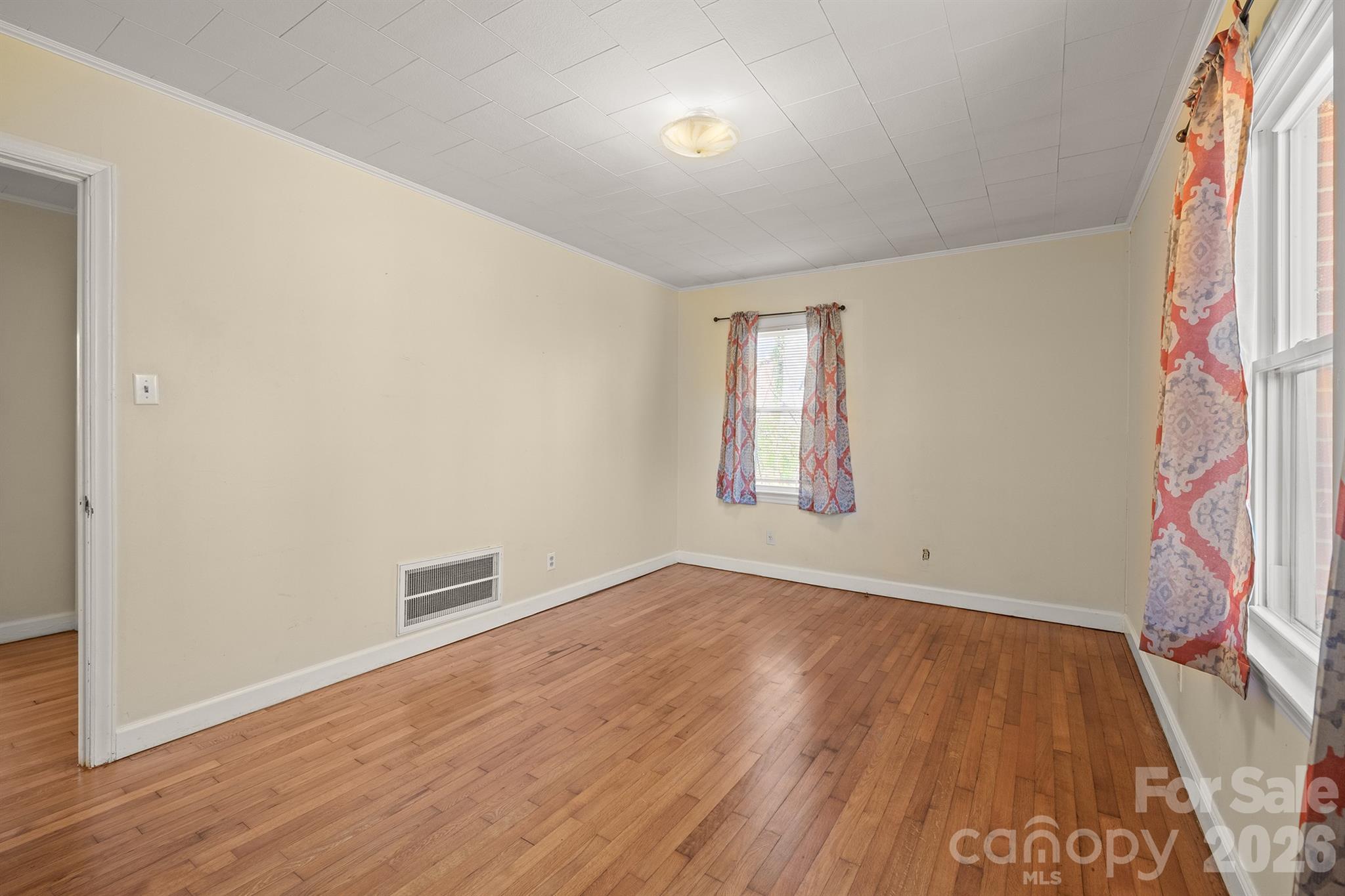 6264 Highway 221 Marion, NC 28752 - Photo 33 of 41 an empty room with wooden floor and windows