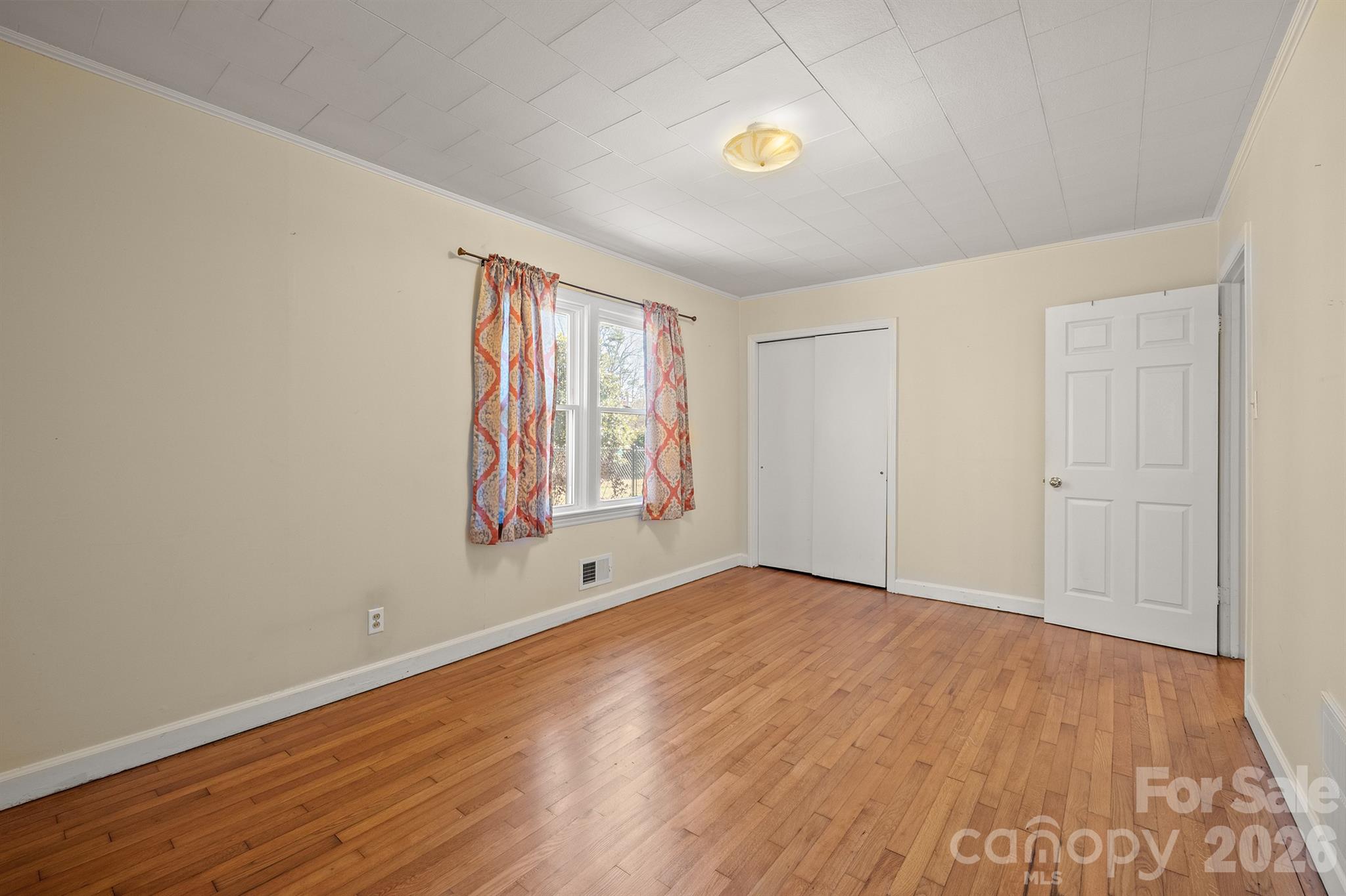 6264 Highway 221 Marion, NC 28752 - Photo 35 of 41 an empty room with wooden floor and windows