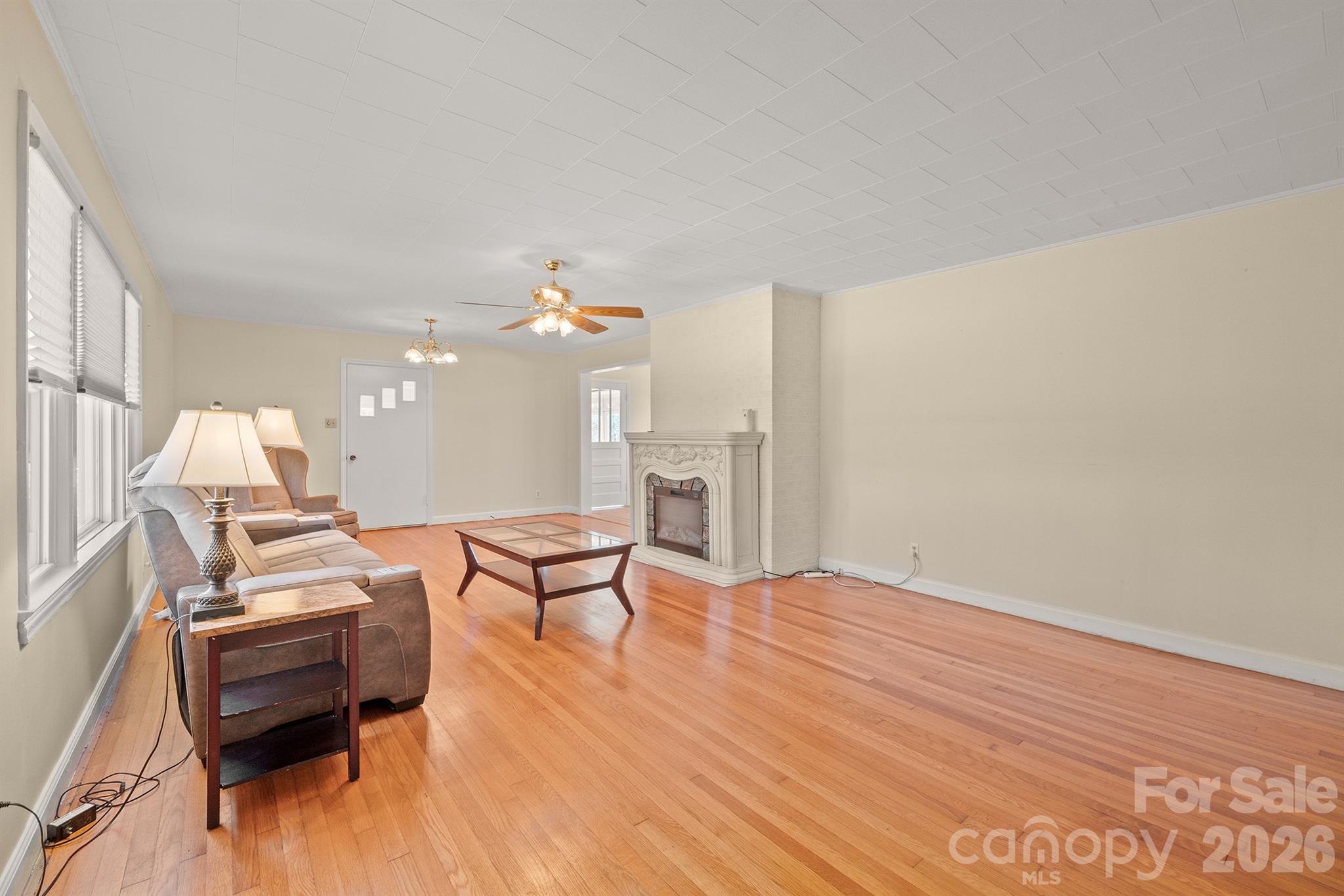 6264 Highway 221 Marion, NC 28752 - Photo 10 of 41 a living room with furniture and a chandelier