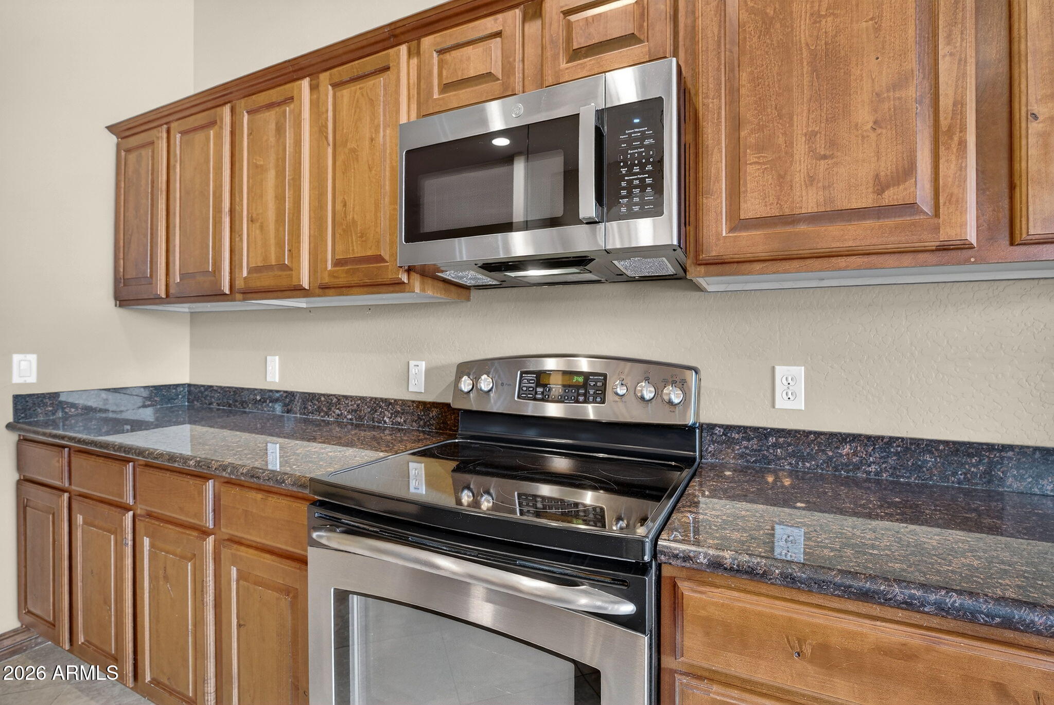 10000 Ginger Way Casa Grande, AZ 85194 - Photo 27 of 93 a kitchen with stainless steel appliances granite countertop white cabinets and a stove top oven