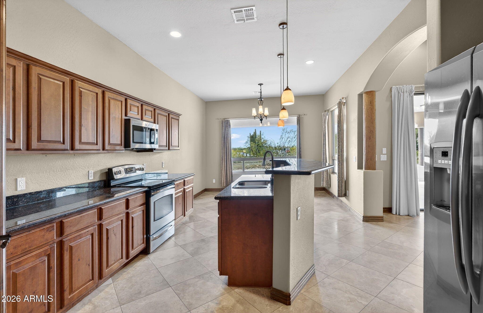 10000 Ginger Way Casa Grande, AZ 85194 - Photo 29 of 93 a kitchen with stainless steel appliances granite countertop a refrigerator a stove a sink a oven and a dining table with wooden floor