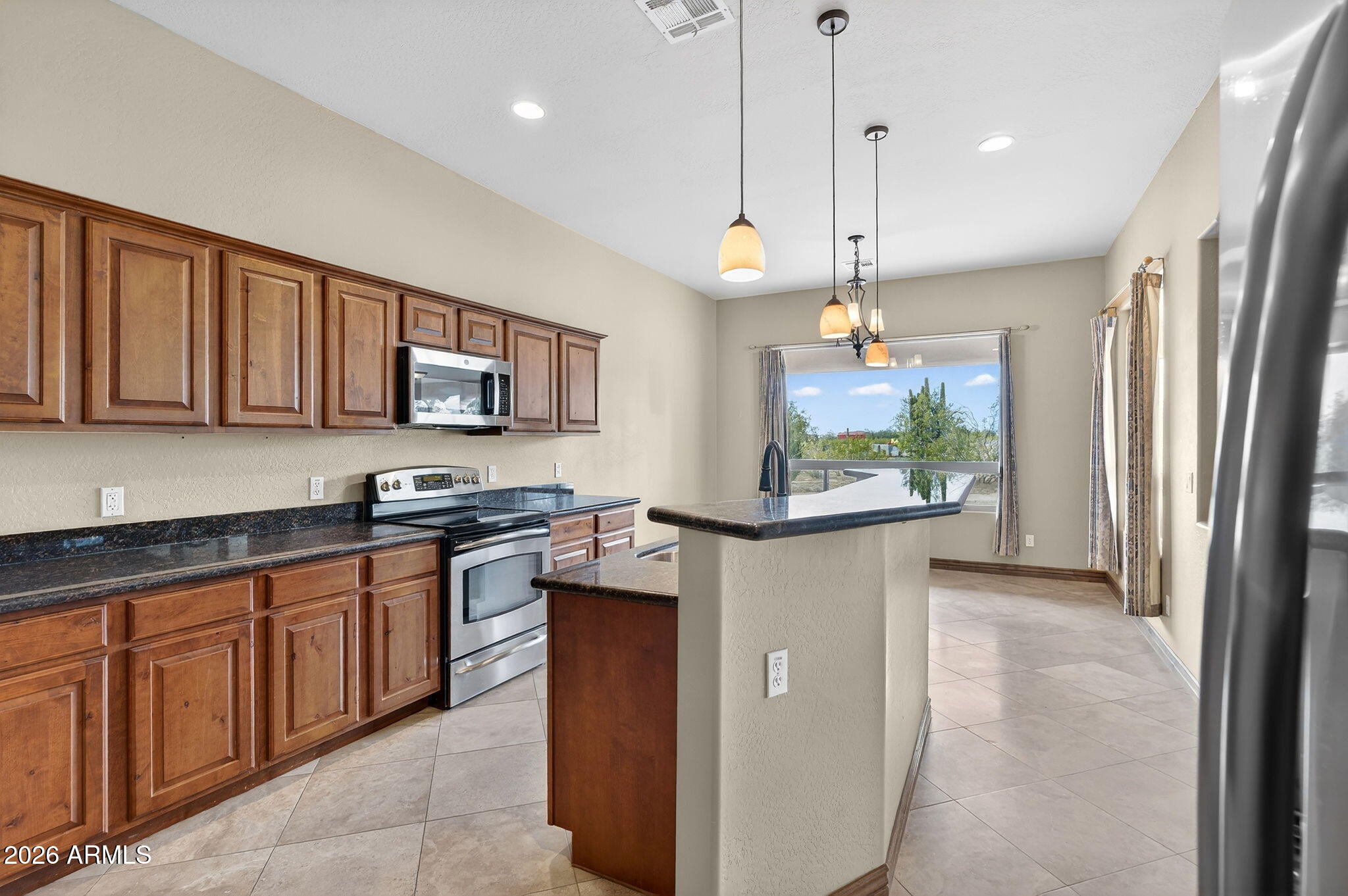 10000 Ginger Way Casa Grande, AZ 85194 - Photo 30 of 93 a kitchen with stainless steel appliances granite countertop a refrigerator a sink dishwasher a stove and a refrigerator with wooden floor