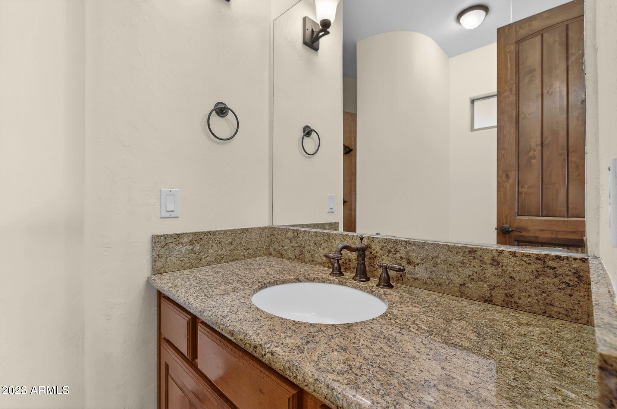 10000 Ginger Way Casa Grande, AZ 85194 - Photo 48 of 93 a bathroom with a granite countertop sink and a mirror