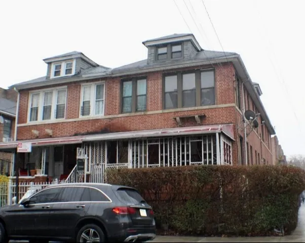 a front view of a house with car parked